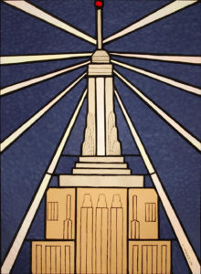 The Art Deco splendor of the Empire State Building with deep blue glass and painted windows and other details onto the glass. The Art Deco splendor of the Empire State Building with deep blue glass and painted windows and other details onto the glass.
